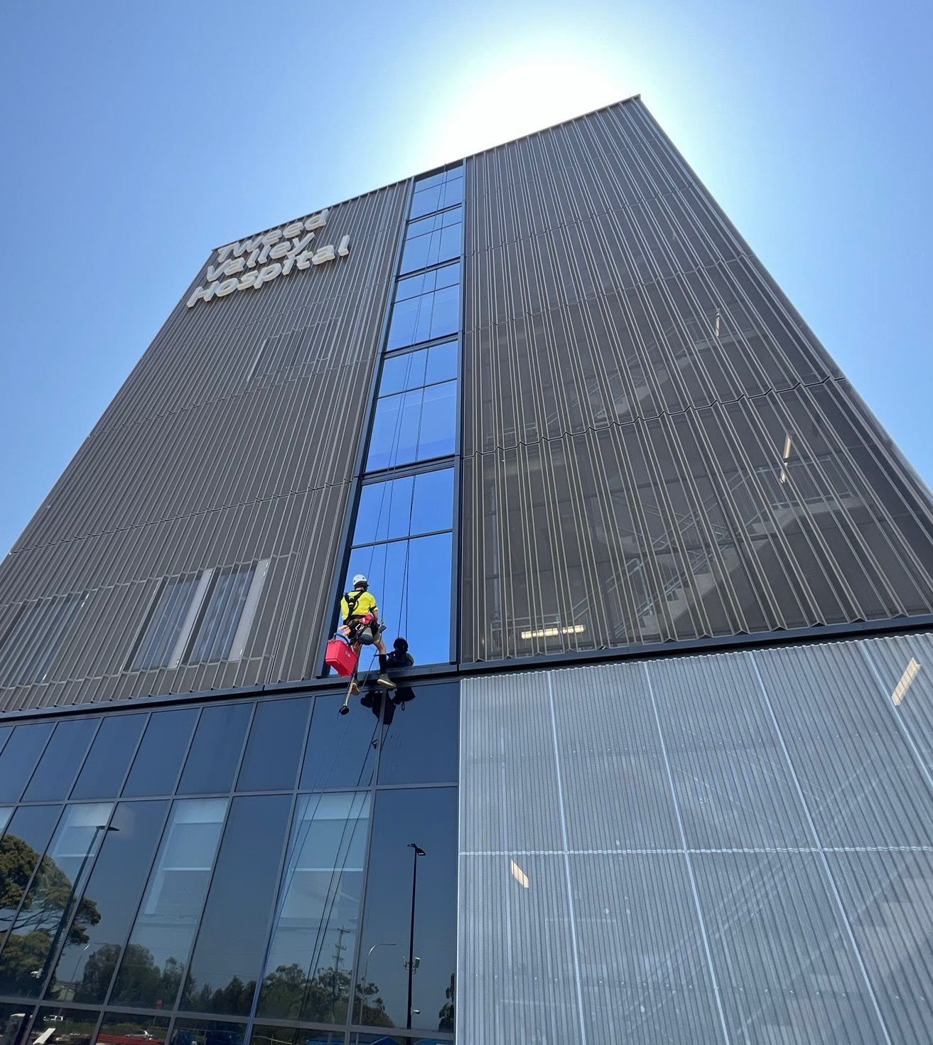 Abseiler on hospital façade