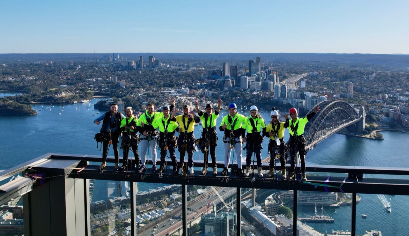 The Select Abseiling team on a rooftop above Sydney Harbour