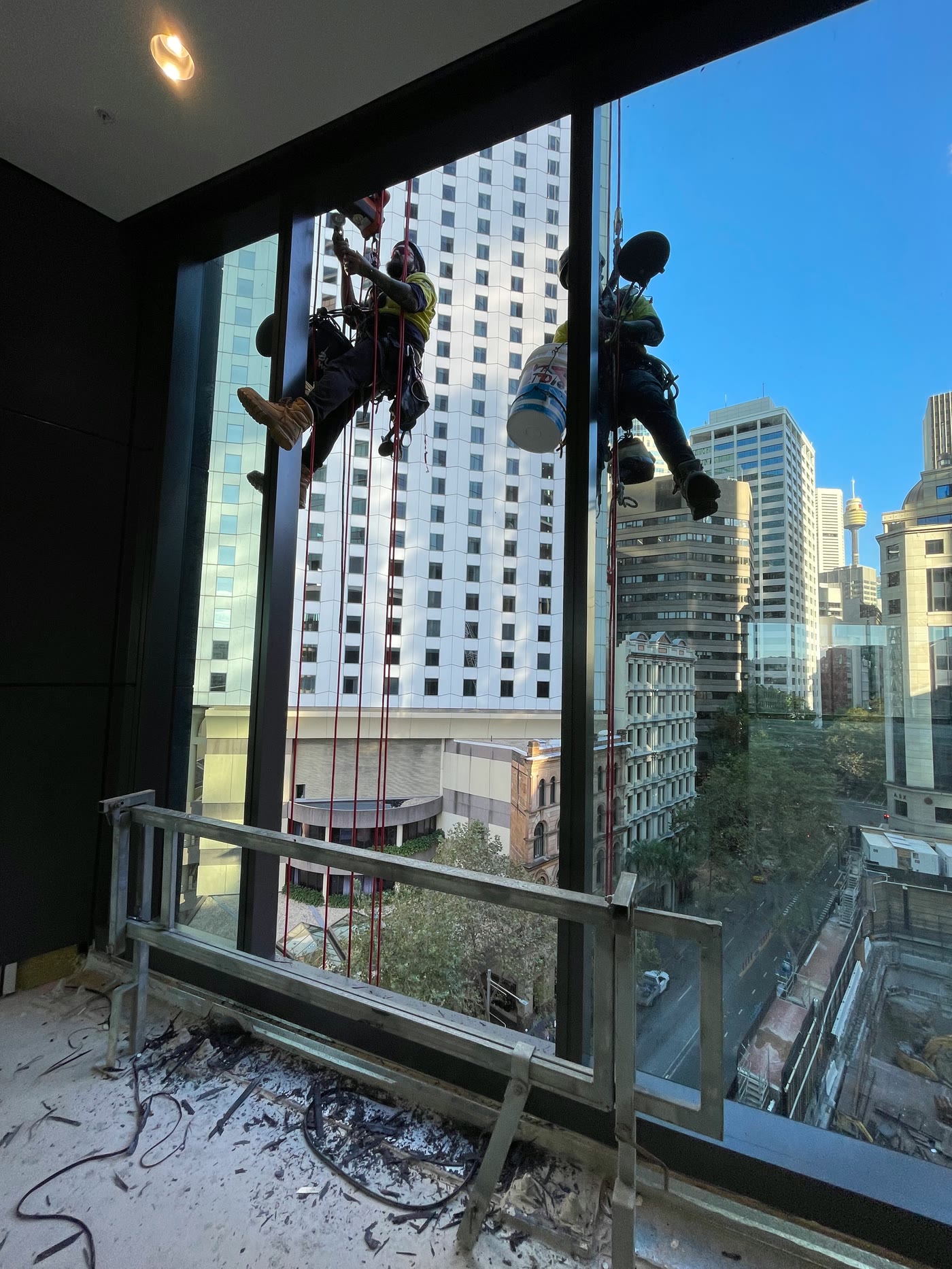 Technicians outside a high-rise window