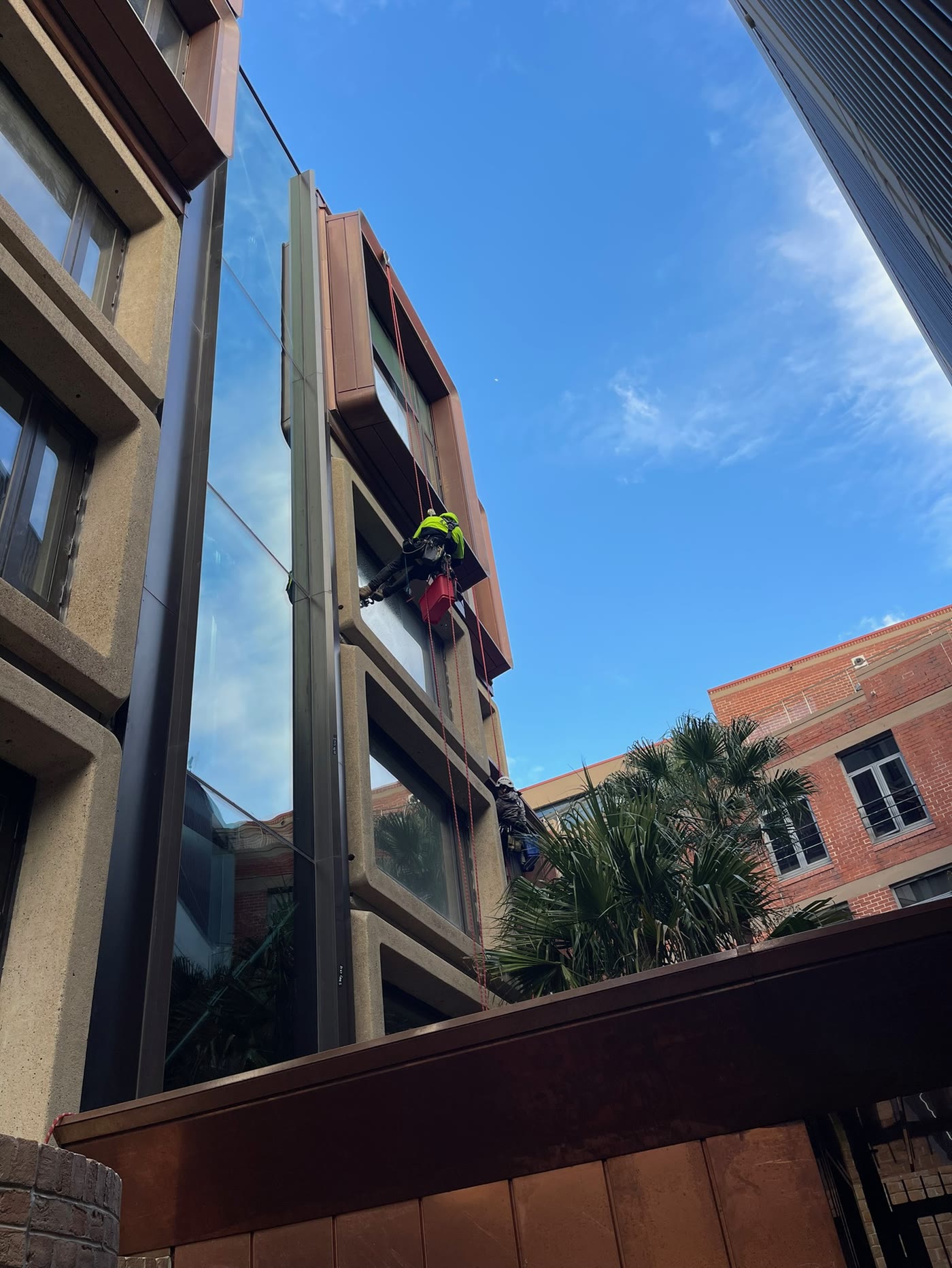 Rope access on a brick and glass building